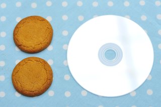 2 ginger nut biscuits next to a CD