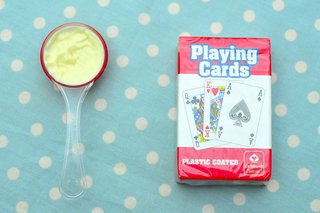 A level tablespoon of mayonnaise next to a pack of cards