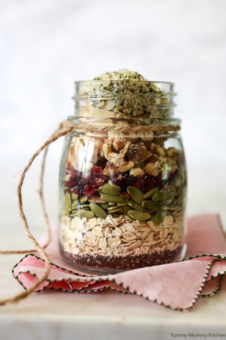 A jar layered with superfood muesli made with oats, chia seeds, pumpkin seeds, cranberries, walnuts, and hemp sees. 